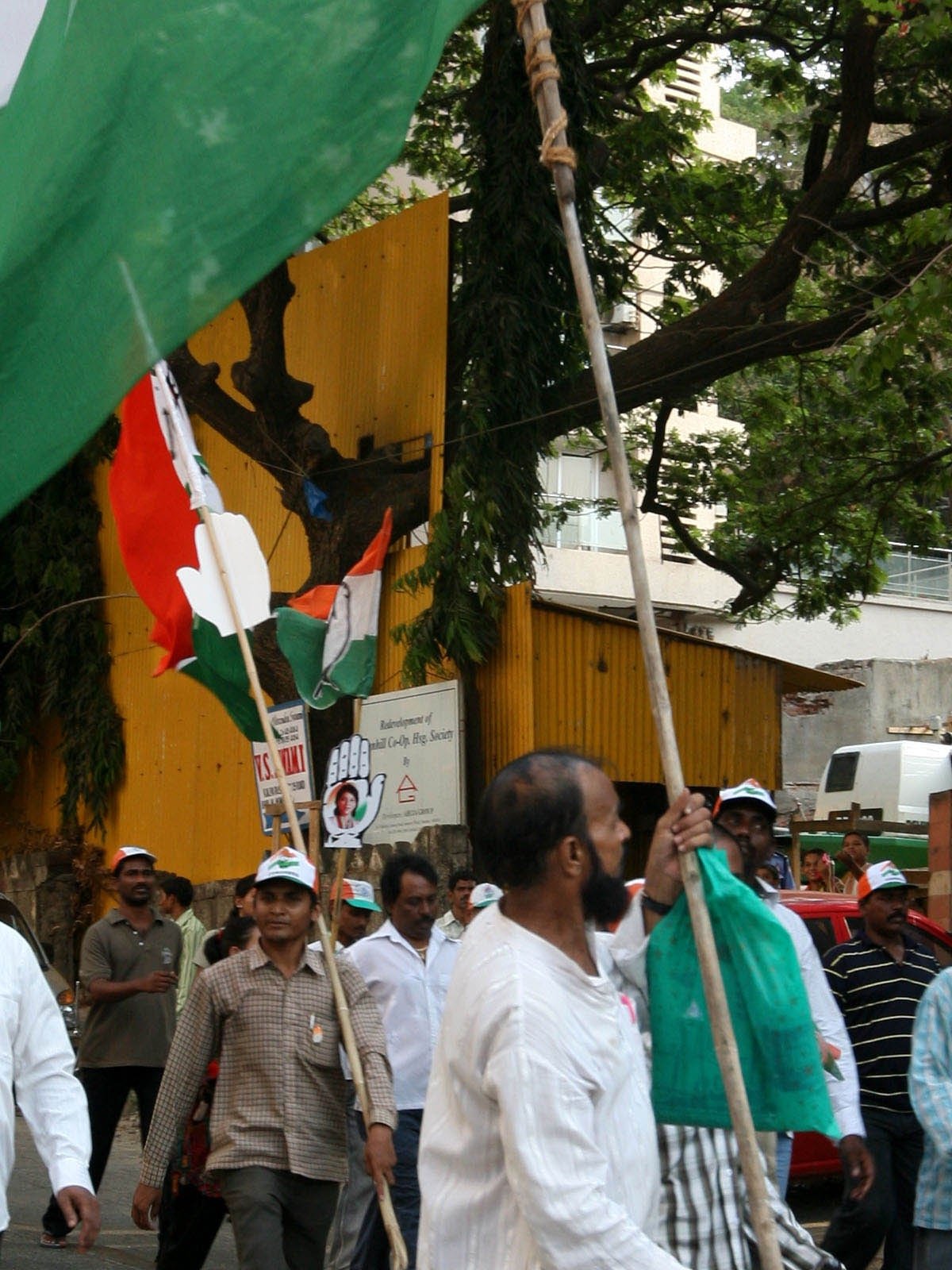 Indian political rally scene with flags and public energy