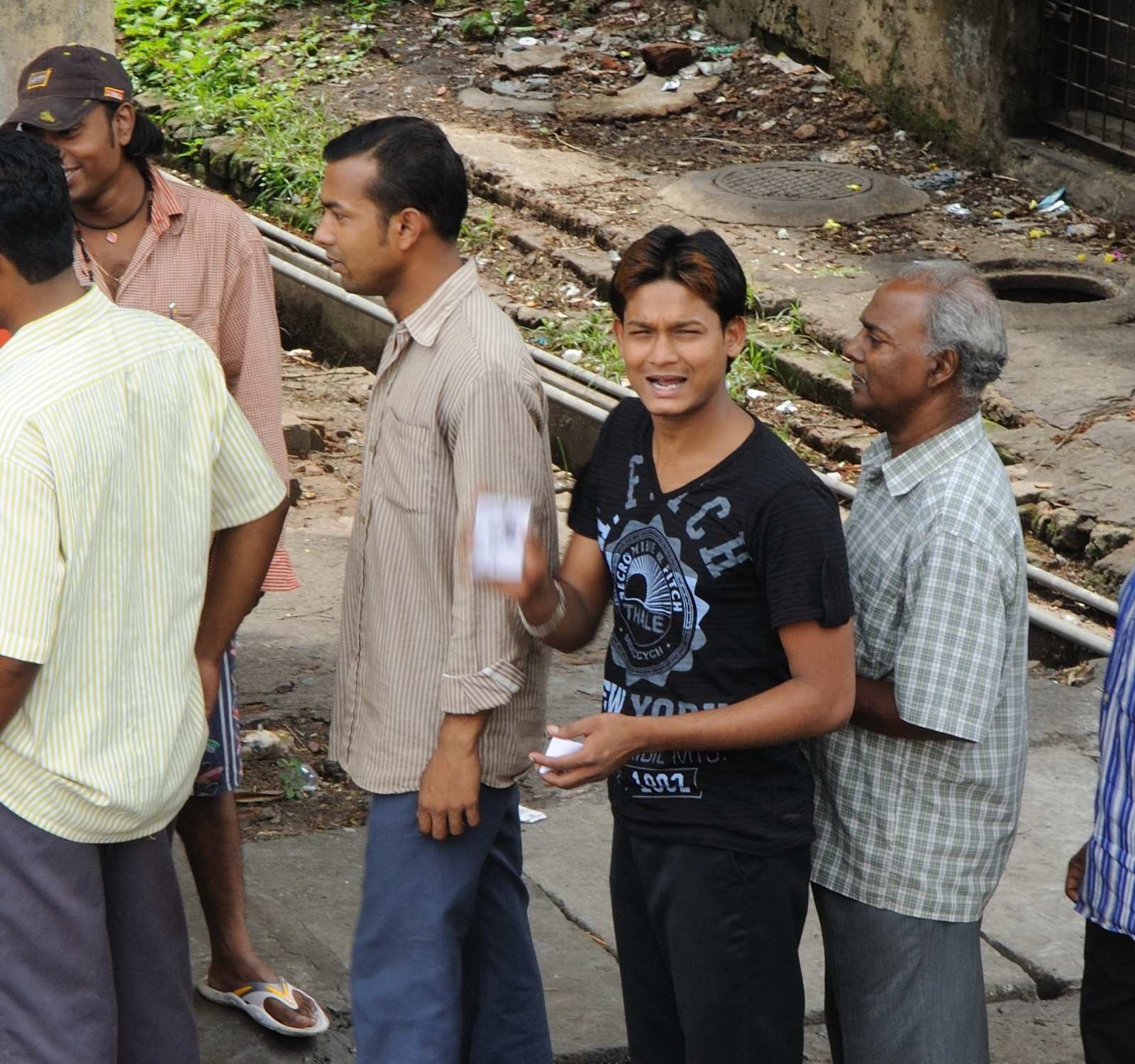 Indian voters standing in queue outside a polling station